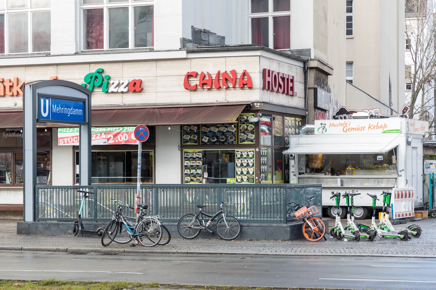 Customers queue beside a compact kebab food trailer on Mehringdamm in Berlin