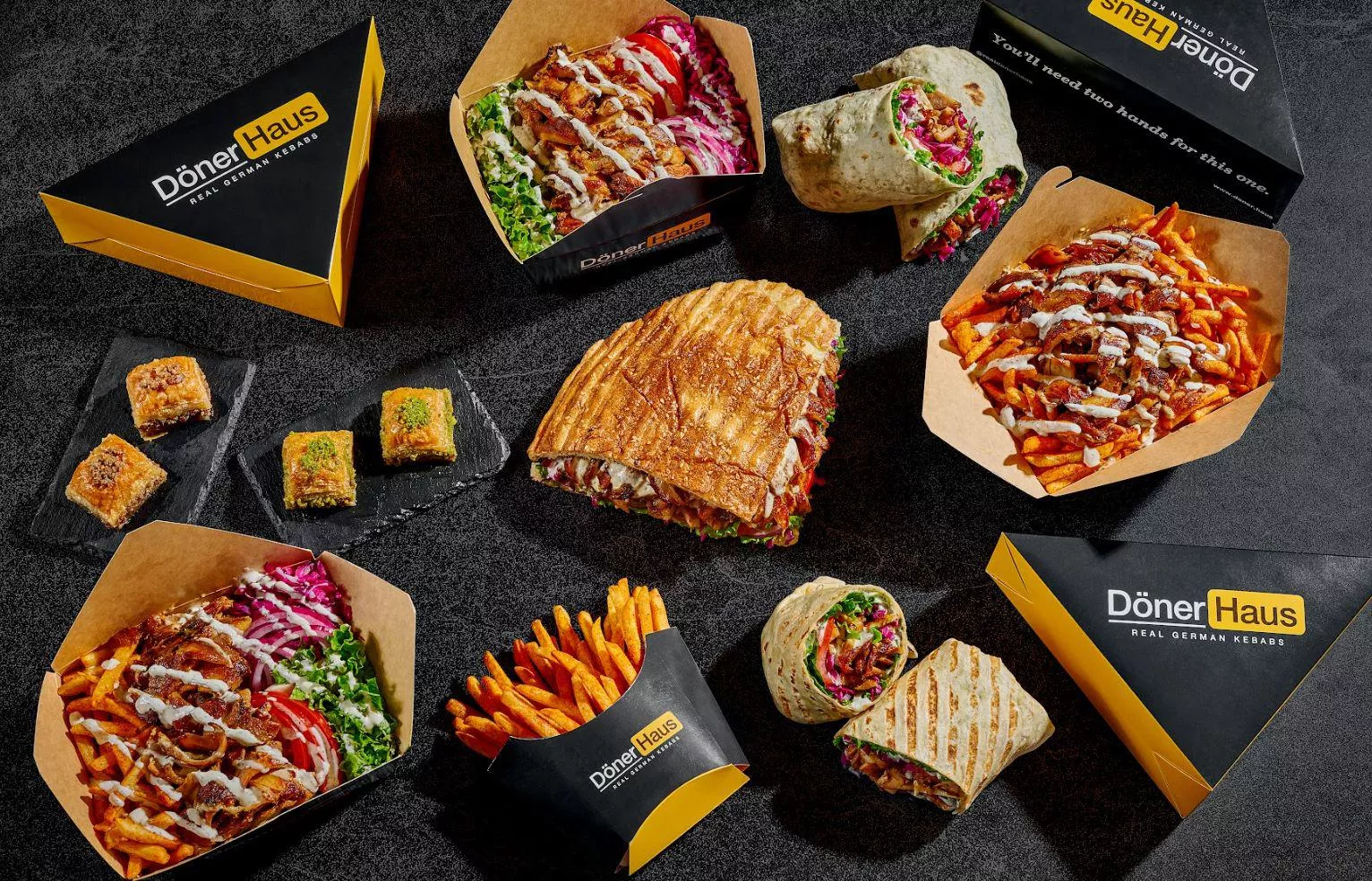 Sandwiches, wraps, boxes and fries laid out together